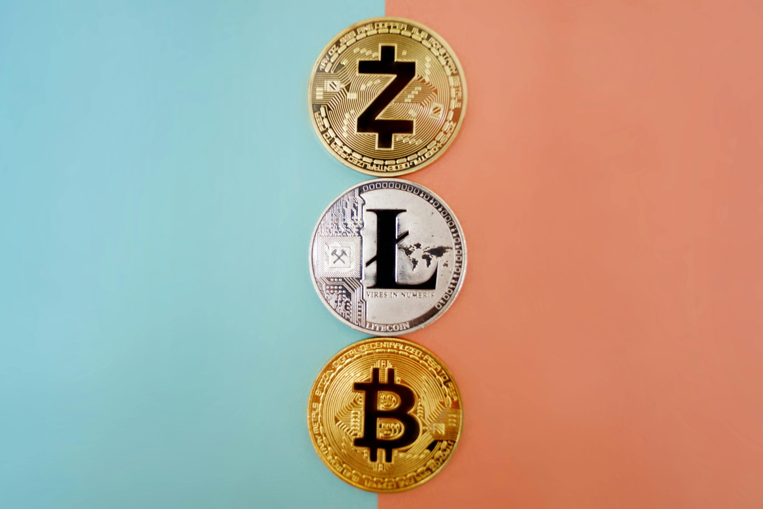 Colorful display of Zcash, Litecoin, and Bitcoin coins on gradient background.